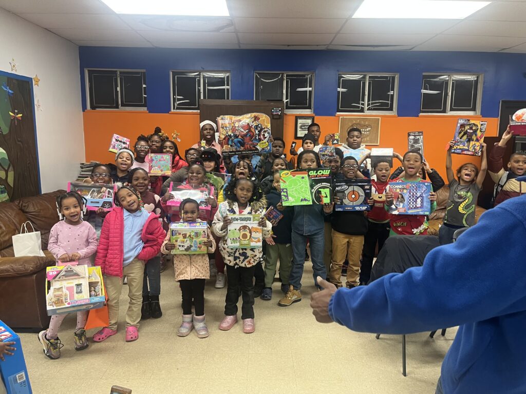 Group of smiling children holding new toys